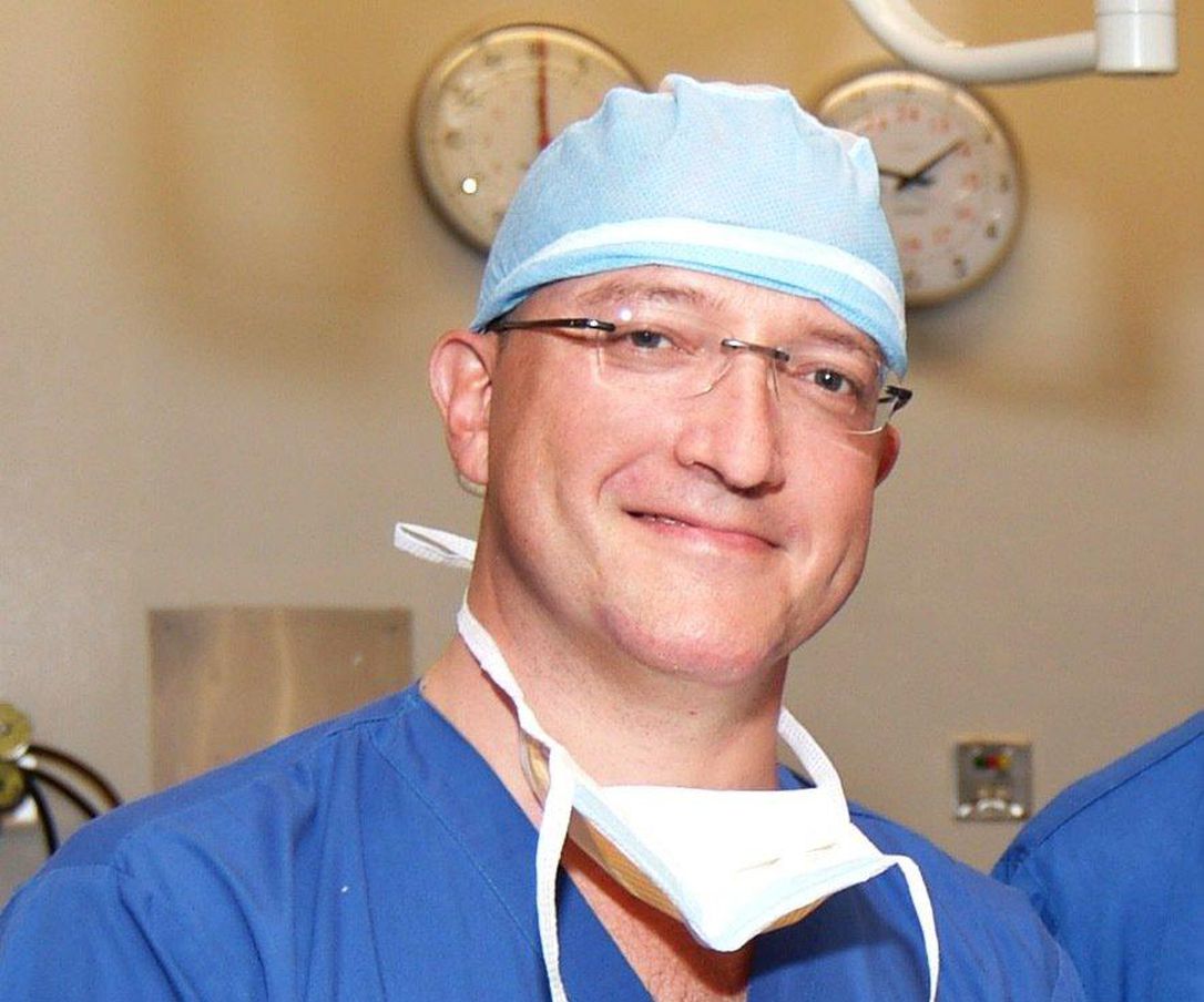 Headshot of Dr. Michael Tymianski wearing operating clothing