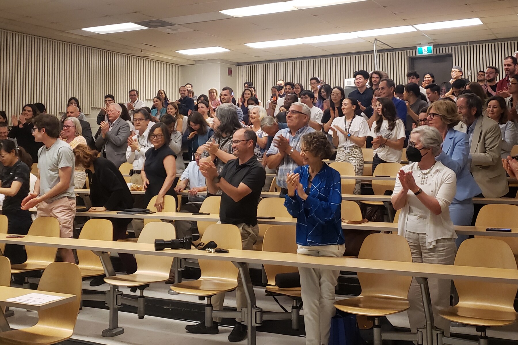 Audience giving a standing ovation for Dr. Brubaker's talk in a lecture theatre