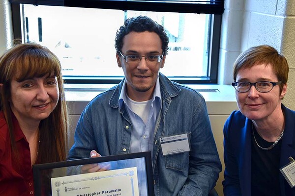 Two professors and a student hold a certificate.